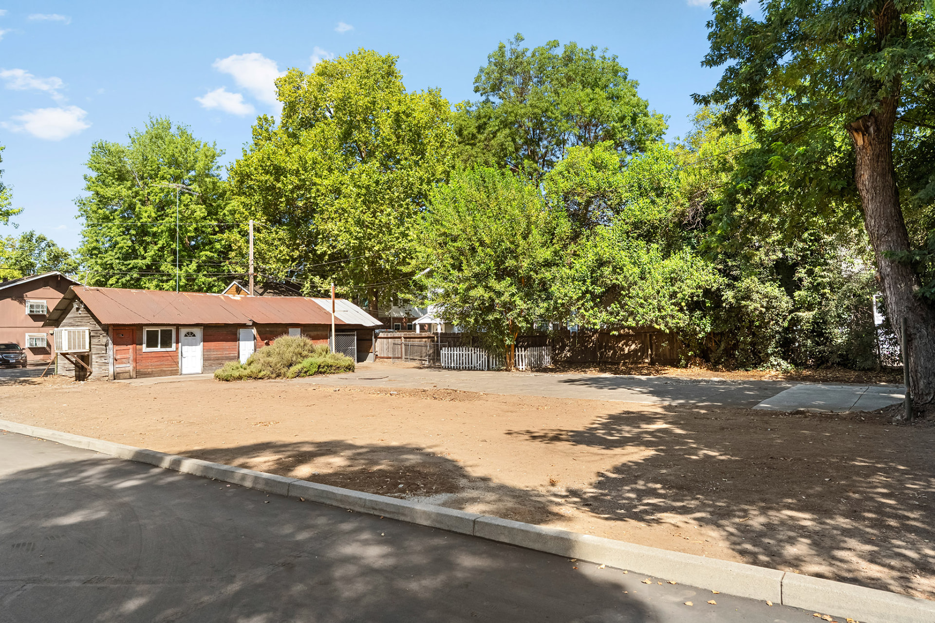 Rear yard and outbuilding with graded area along the property line