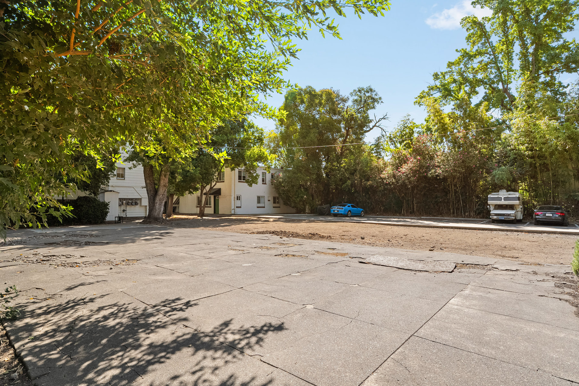 Open parking field looking toward the rear elevation of the apartment building